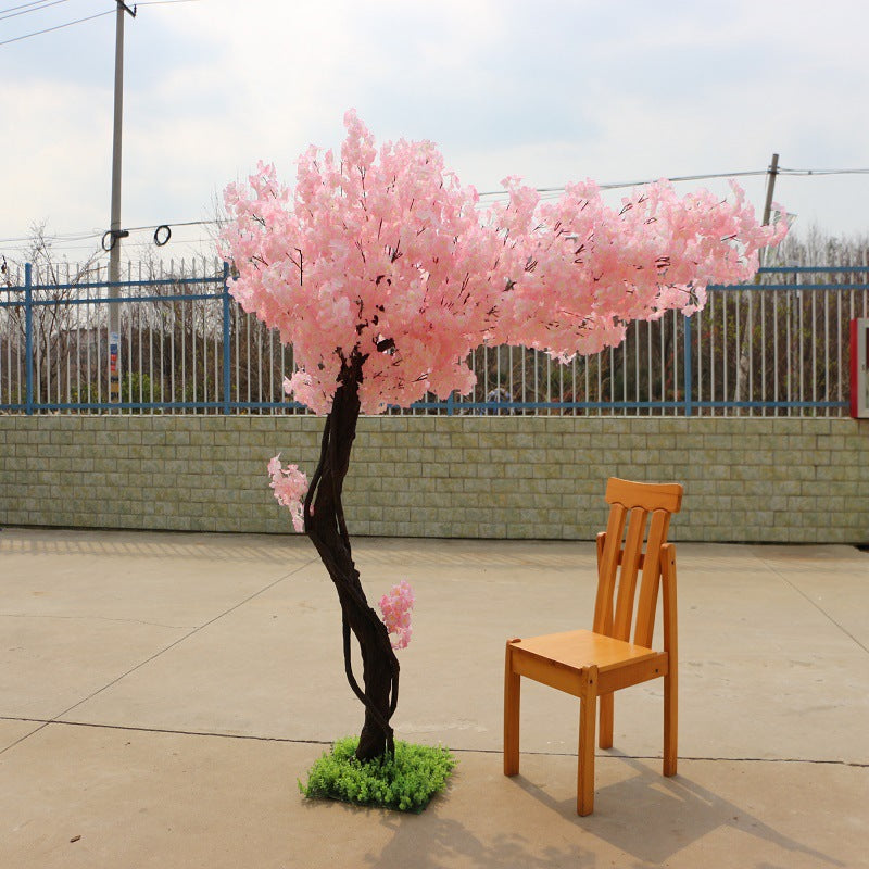 The blossom tree used outdoors at a garden wedding beside the guest aisle