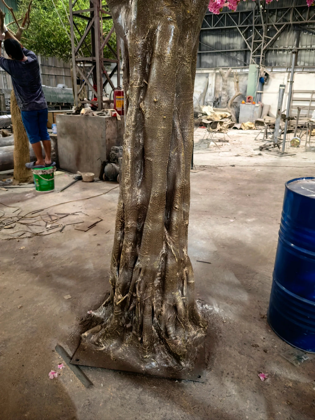 Base of the 16ft cherry blossom tree where the trunk meets its planter