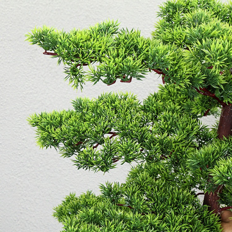 Close-up of the plastic pine needles bunched into flat, layered green pads