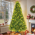 The lit 9ft spruce turning on its rotating base in an indoor holiday display