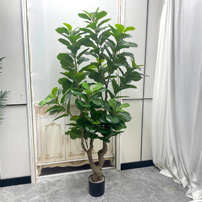 The fiddle leaf fig in a hotel lobby standing beside a lounge chair