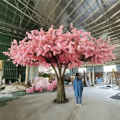 Artificial cherry blossom tree with pink flowers massed across bare branches