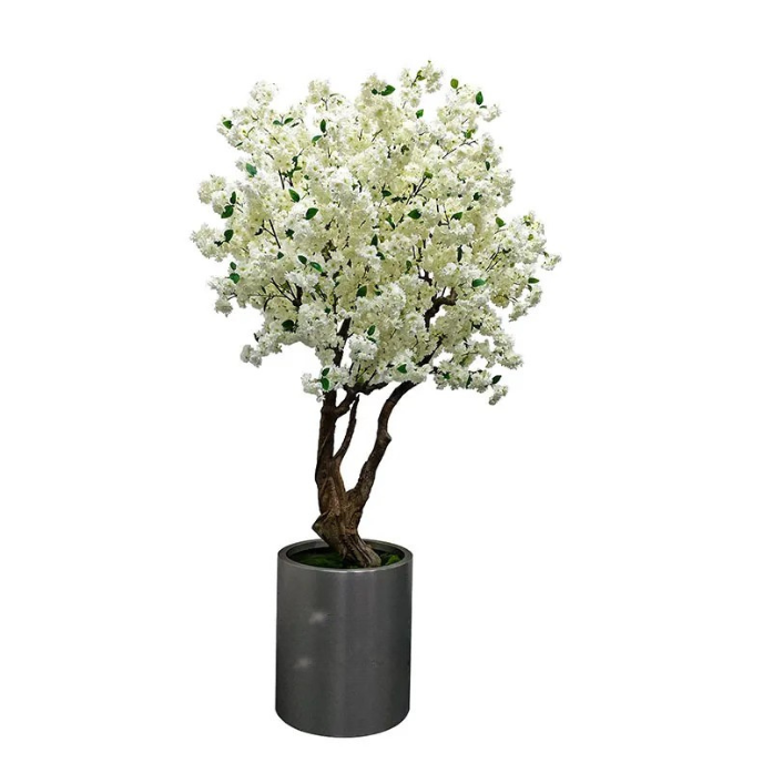 The blossom tree in an interior display, flowers spread above the floor