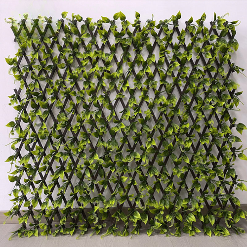 Artificial leaf trellis fence expanded into a green panel of dense PVC plastic foliage