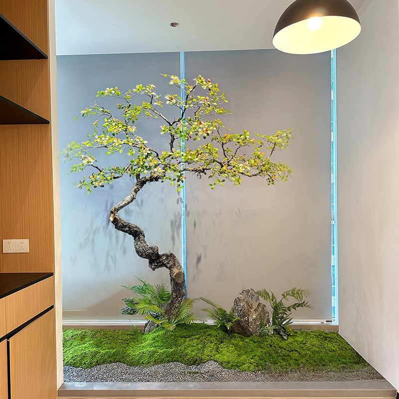 Large artificial spring flower plant, blossom and foliage on a natural wood trunk