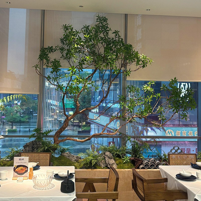 The large tree used indoors as a landscaping feature in an open lobby