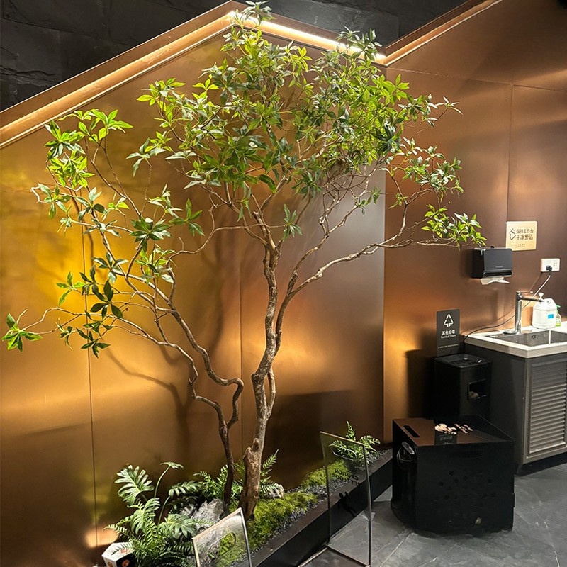 Large artificial tree with a moulded wood trunk and dense green foliage above
