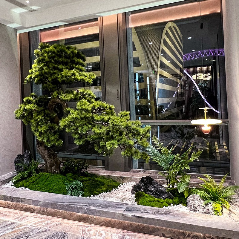 Base of the artificial pine where the trunk meets its floor planter