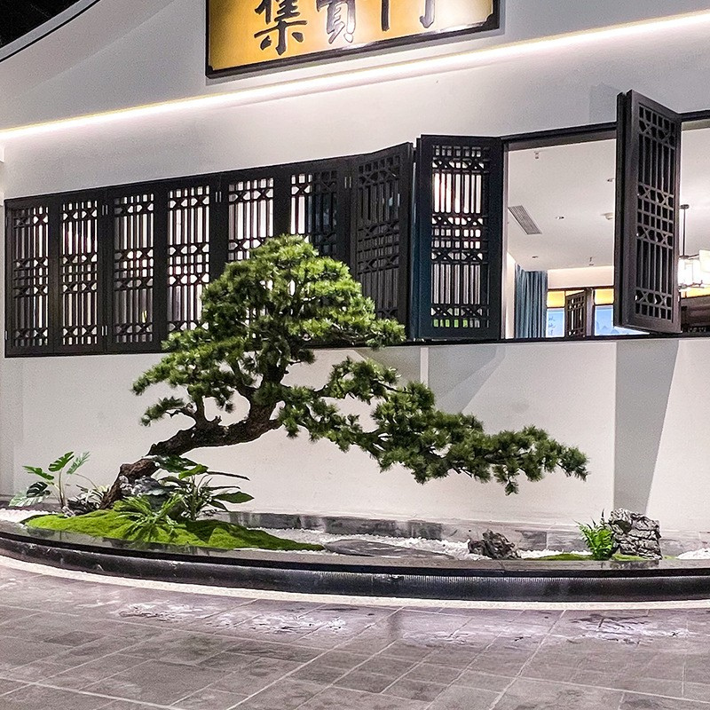 The pine tree's silhouette seen against a bright full-height window