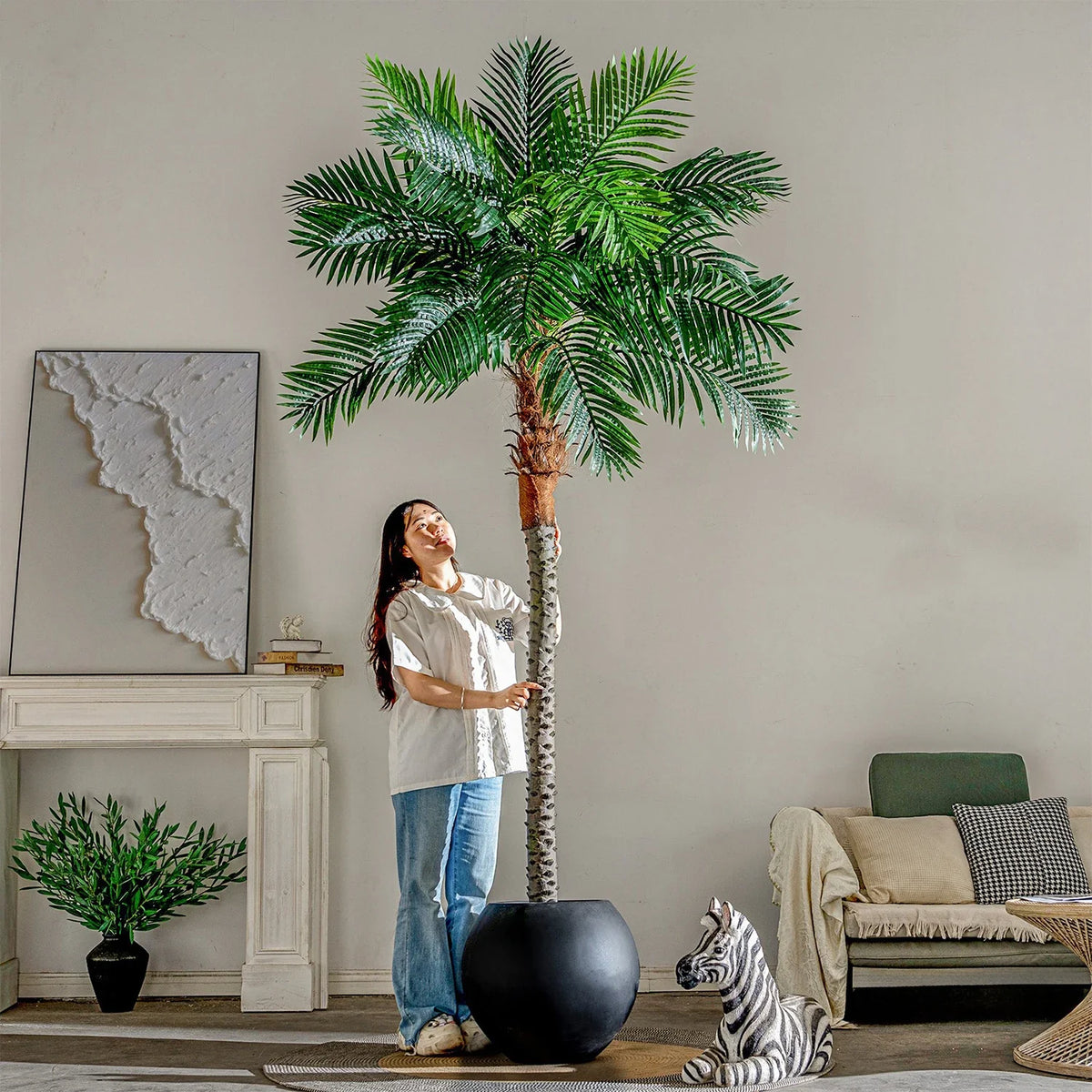 The pot and base of the plastic artificial coconut palm, topped with gravel