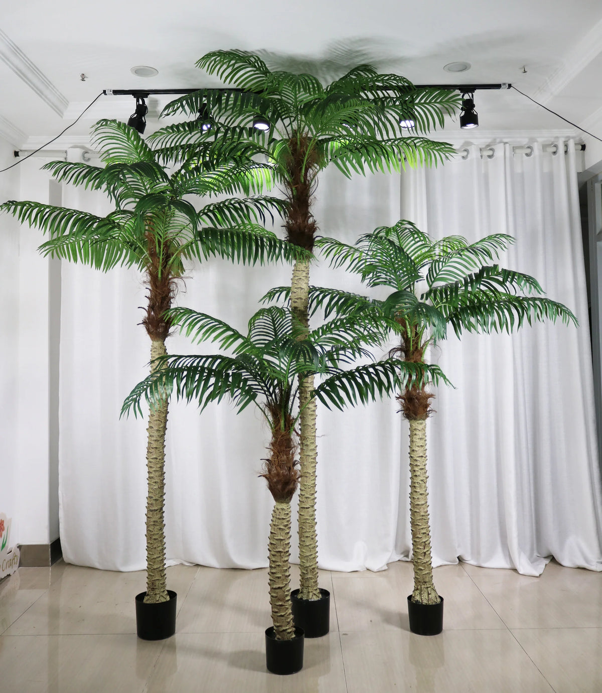 Artificial areca palm in a pot, feathered fronds arching from clustered cane stems