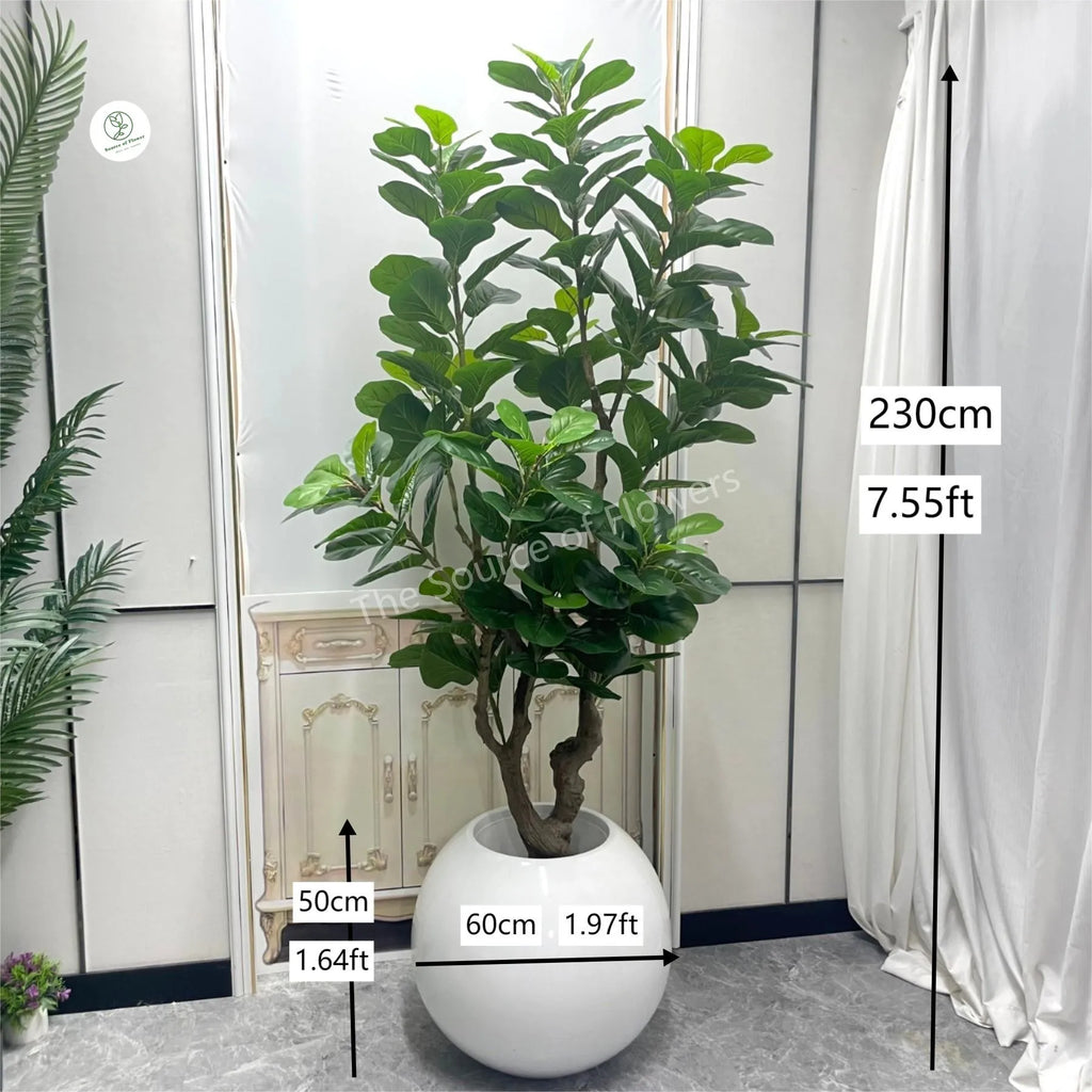 Faux fiddle leaf fig tree with large violin-shaped leaves rising from a potted stem