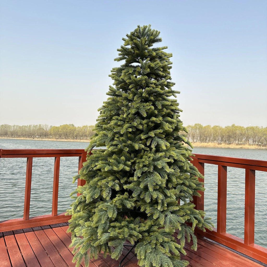 Large artificial spruce Christmas tree with dense, green foliage
