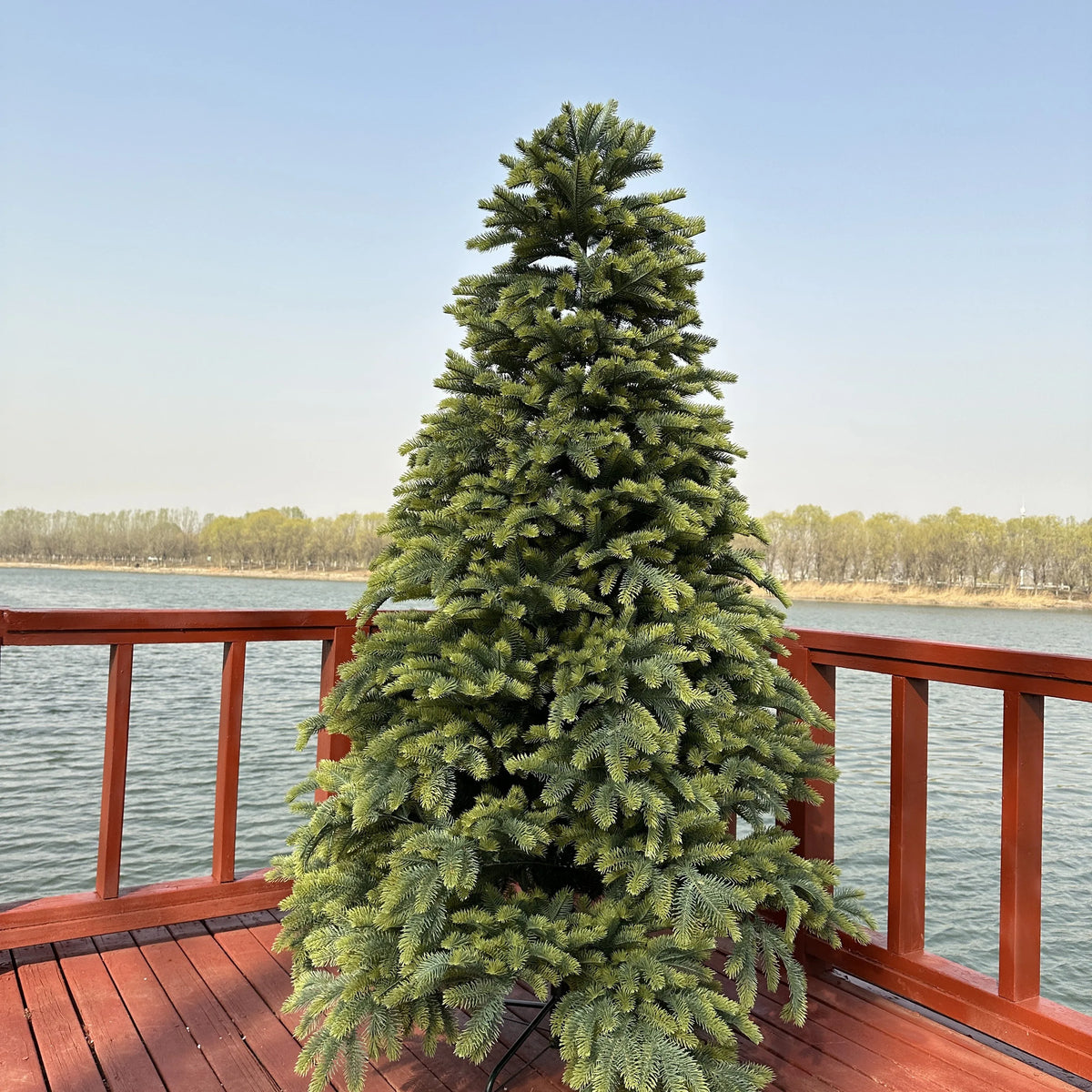 Large artificial spruce Christmas tree with dense, green foliage
