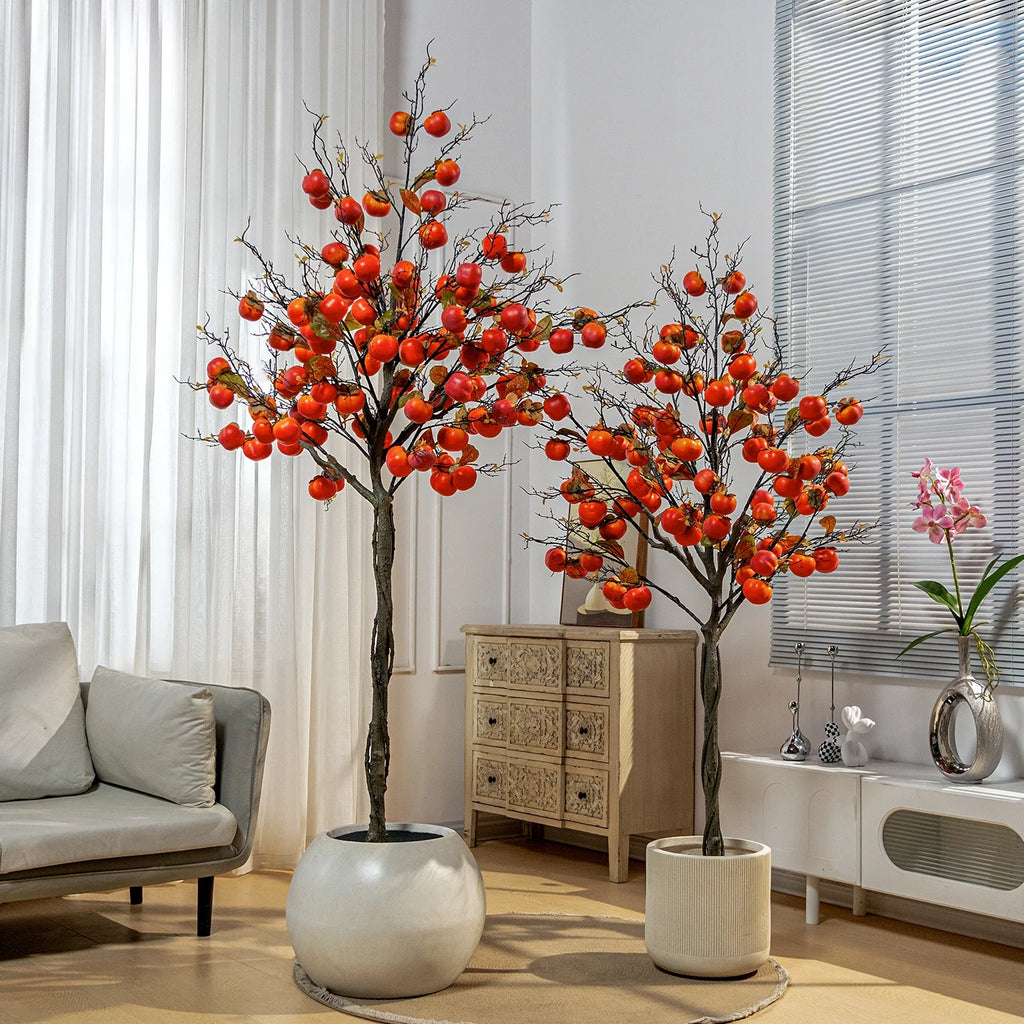 Artificial persimmon tree hung with realistic red fruit among deep green leaves