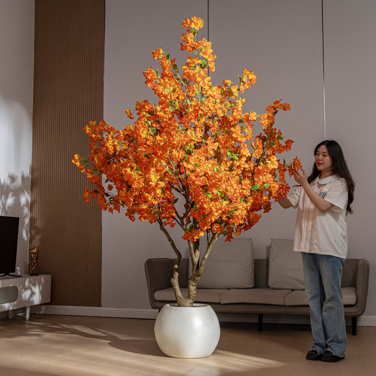 The white pot and base of the 7ft artificial bougainvillea, topped with moss