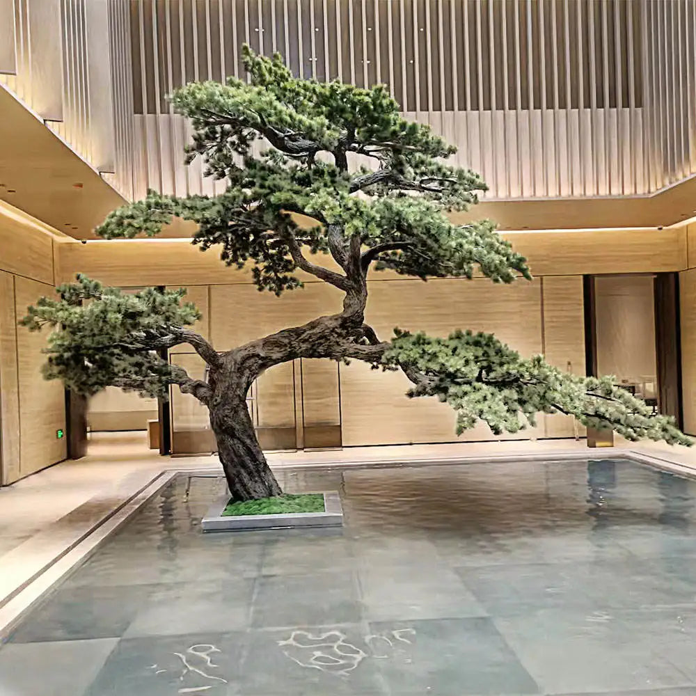 Artificial pine bonsai in plastic and silk, branches shaped into layered green pads