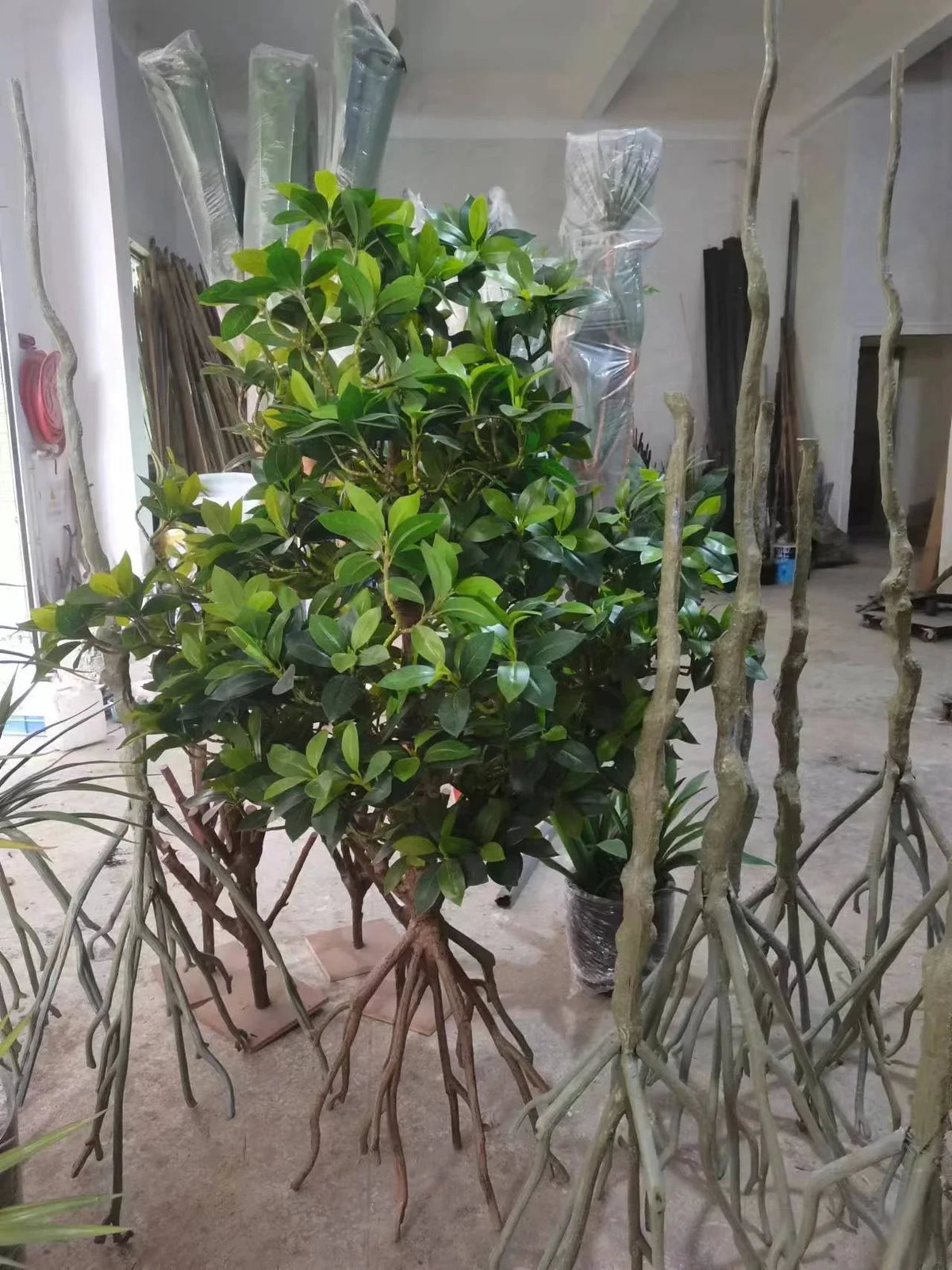 The tangled aerial root structure at the base of the artificial mangrove