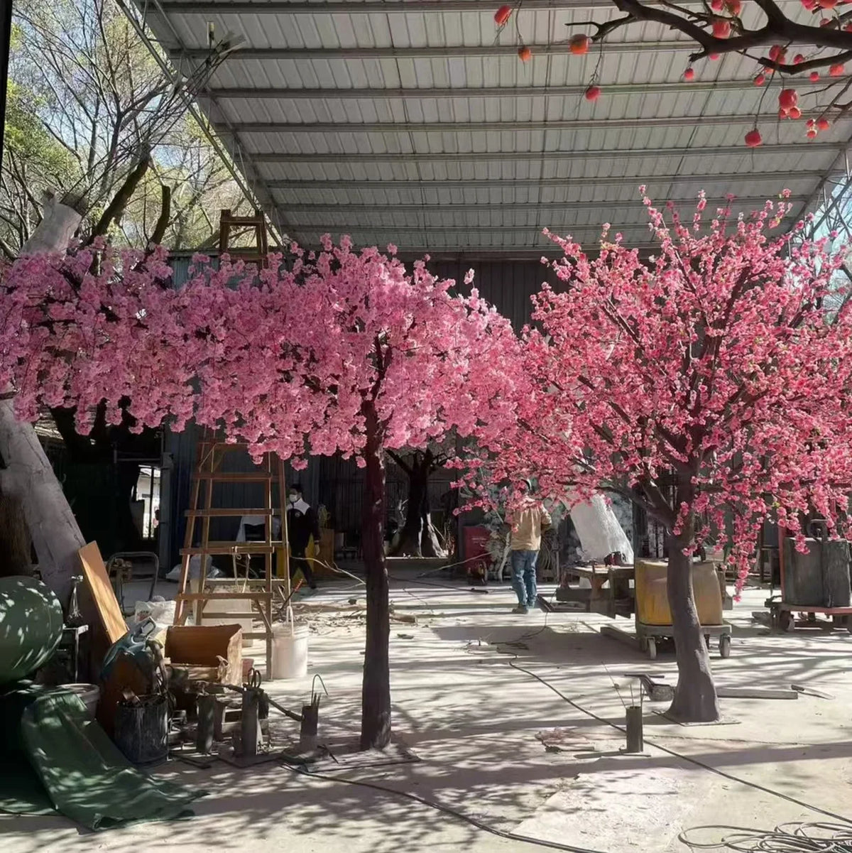The trunk and branch frame of the sakura tree beneath its pink flowers