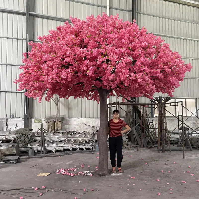 The 15ft blossom tree used as a backdrop behind a wedding ceremony aisle
