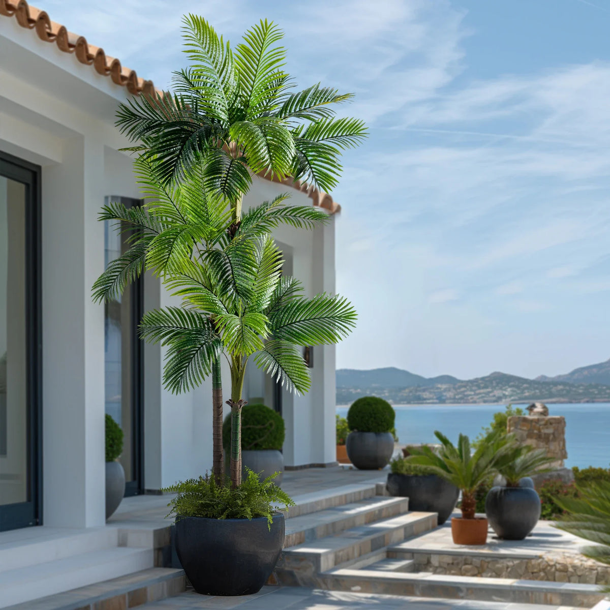 Artificial palm tree 9ft (2.7m) tall with broad green fronds and a textured trunk