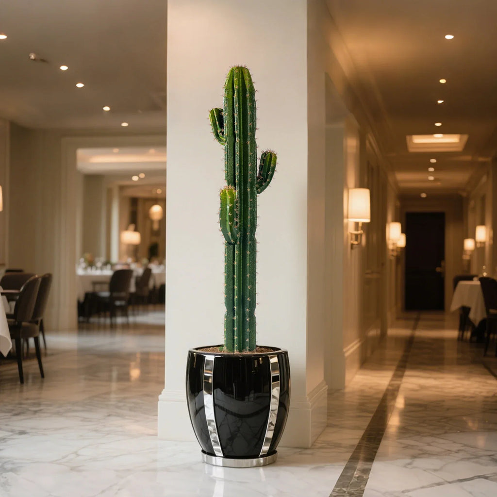 The faux cactus in a living room corner standing beside a pale plaster wall
