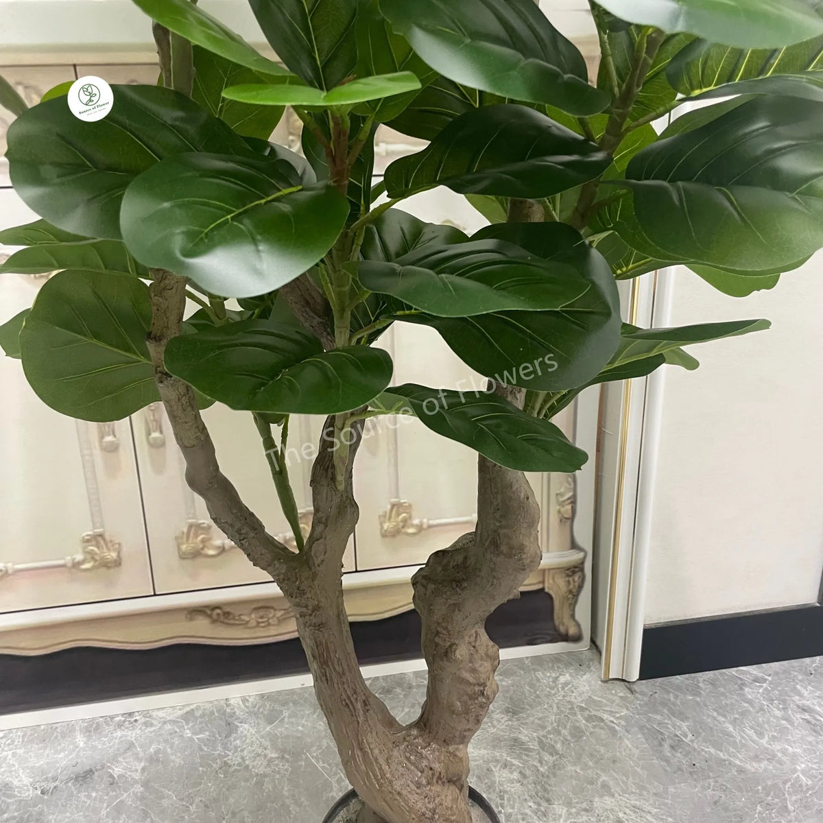 Pot and base of the artificial fiddle leaf fig, topped with bark and moss