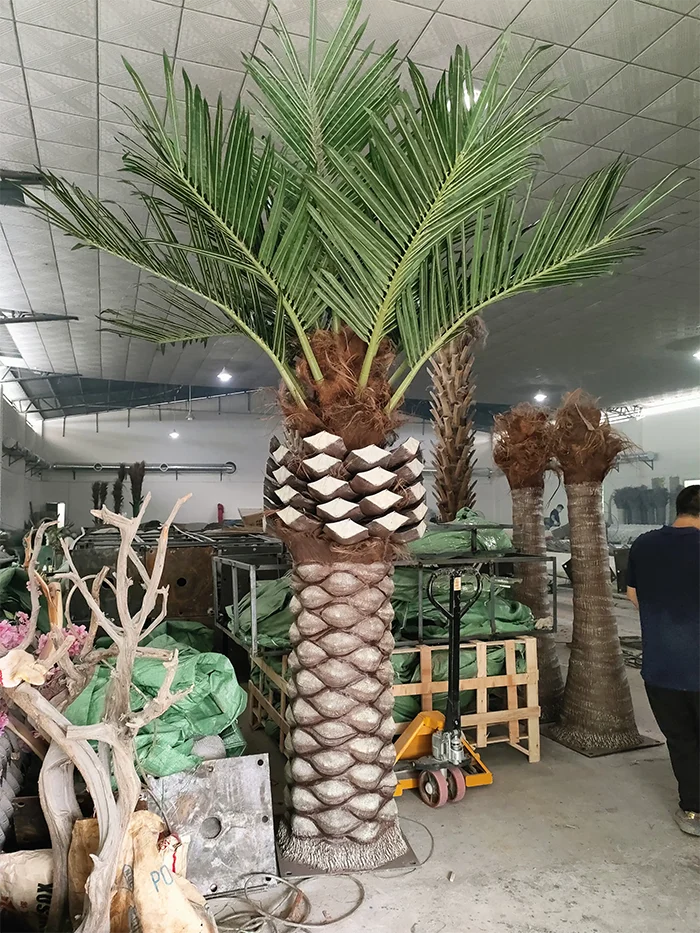 The ringed trunk of the 3m coconut tree, textured like real palm bark