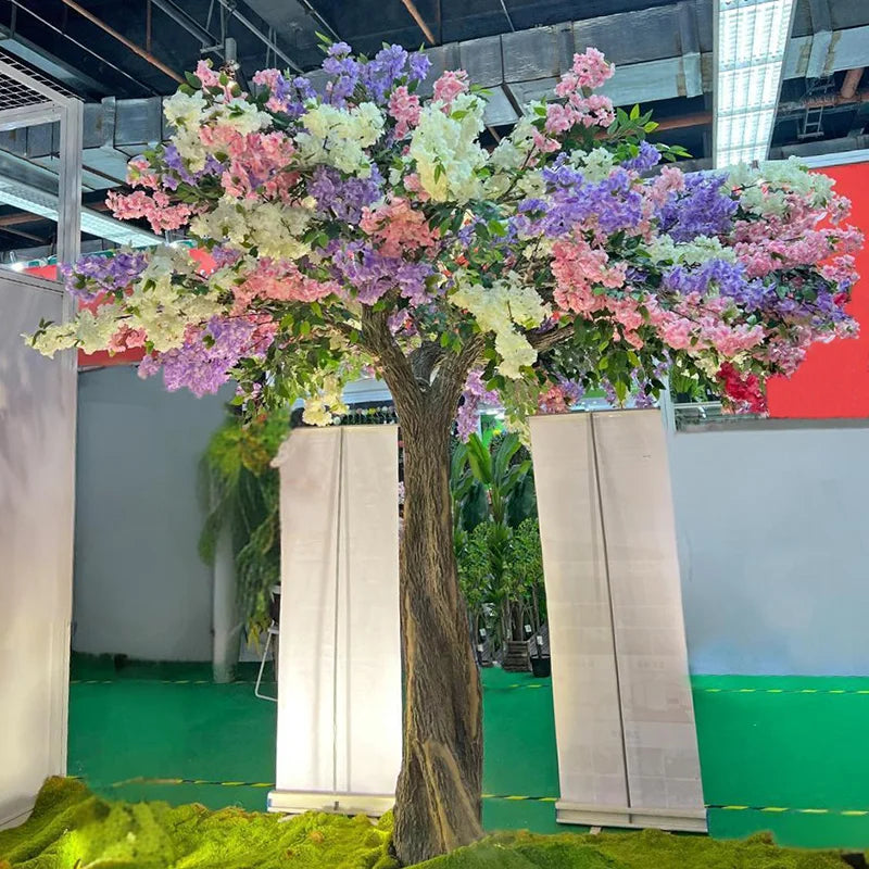 The lit blossom tree glowing after dark against a dark interior backdrop
