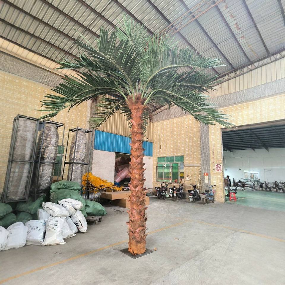 Curved artificial palms planted along the edge of a hotel pool terrace