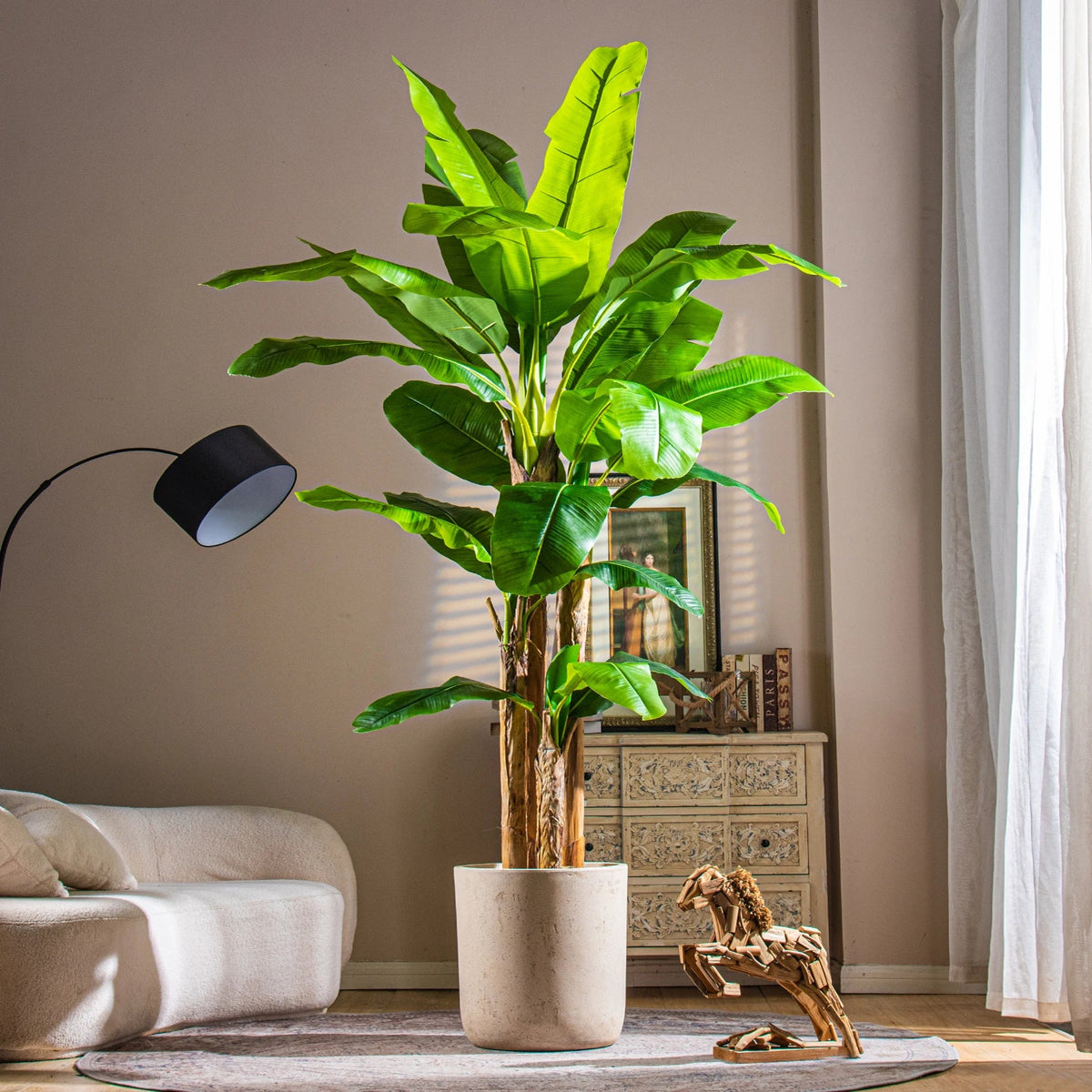 The 6.6ft banana tree in a hotel lobby standing beside a seating group