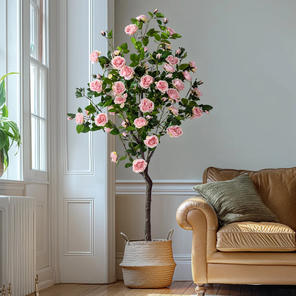 The artificial rose tree in a hotel lobby standing beside a console table
