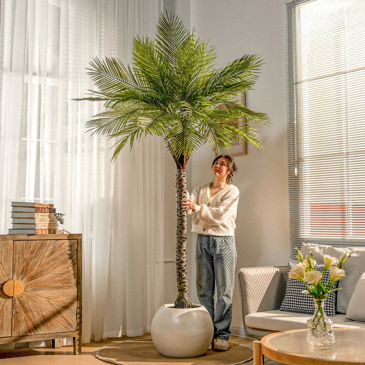 Artificial palm tree 7.5ft tall, potted, broad fronds arching out from the crown