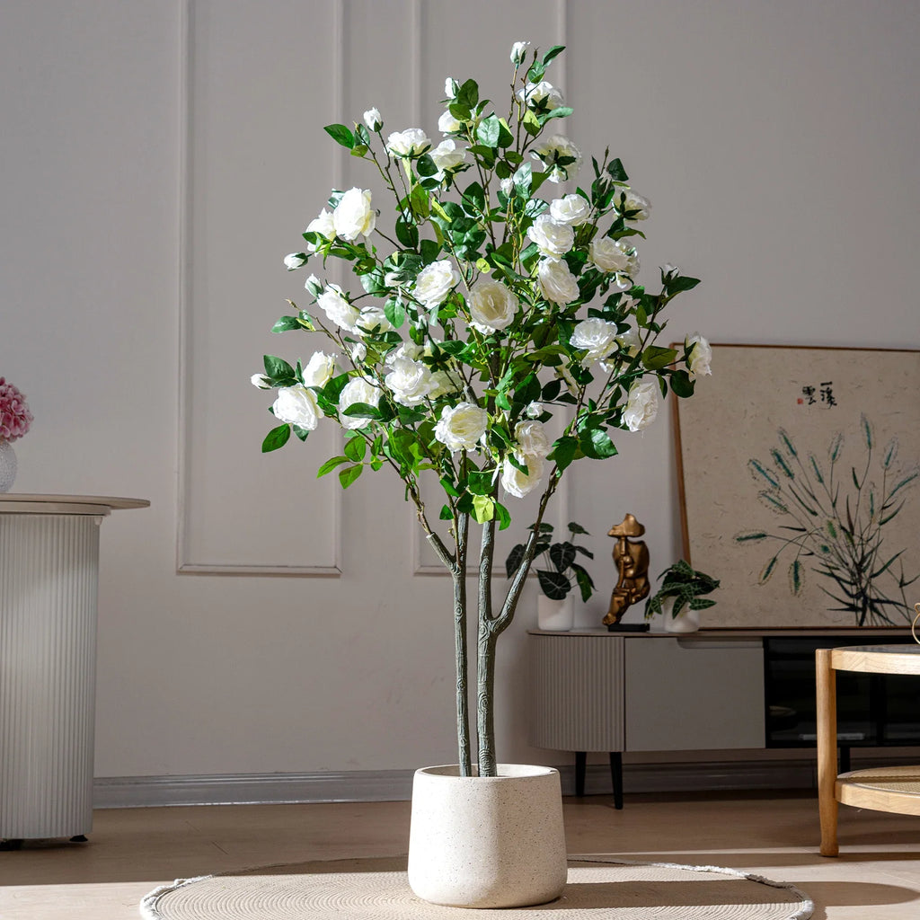 The slim trunk of the 5.5ft rose tree rising into the ball of flowers