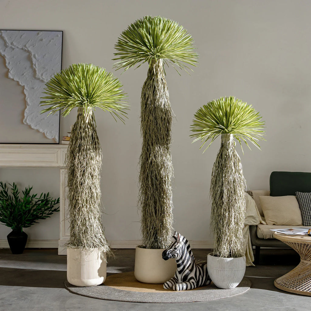 Pot and base of the artificial dracaena tree, topped with moss and bark