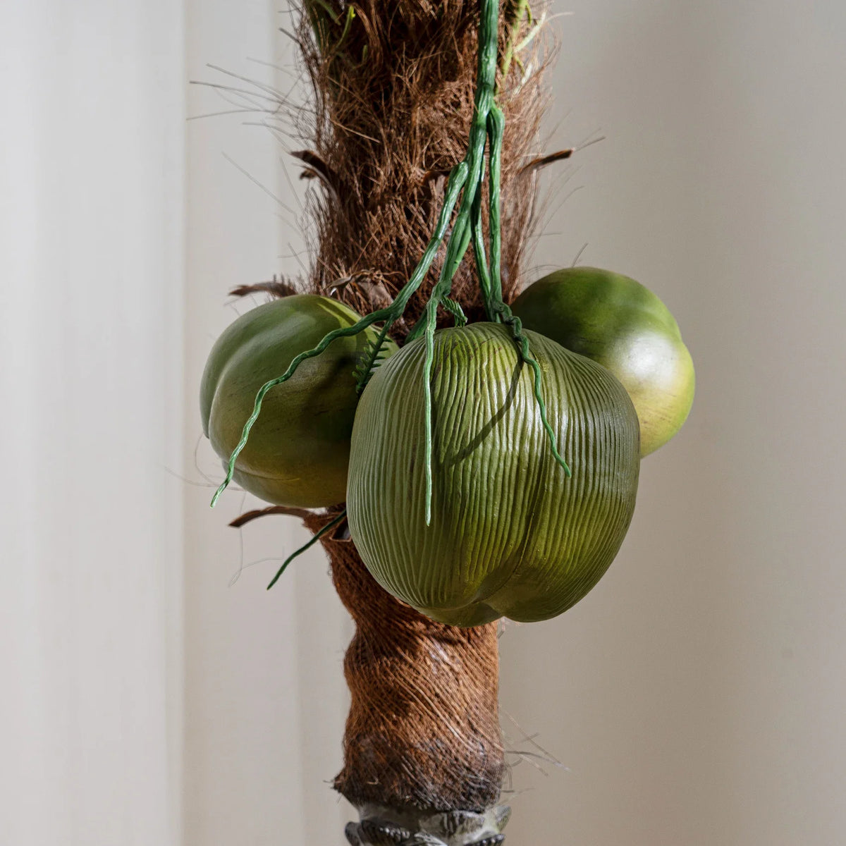 The same coconut tree used outdoors on a patio standing beside seating