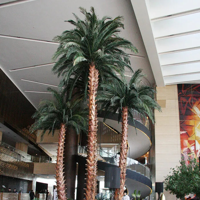 Artificial coconut palm with realistic fronds arching out above a ringed trunk