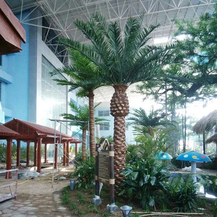 The date palm planted in a garden landscape beside a paved stone terrace
