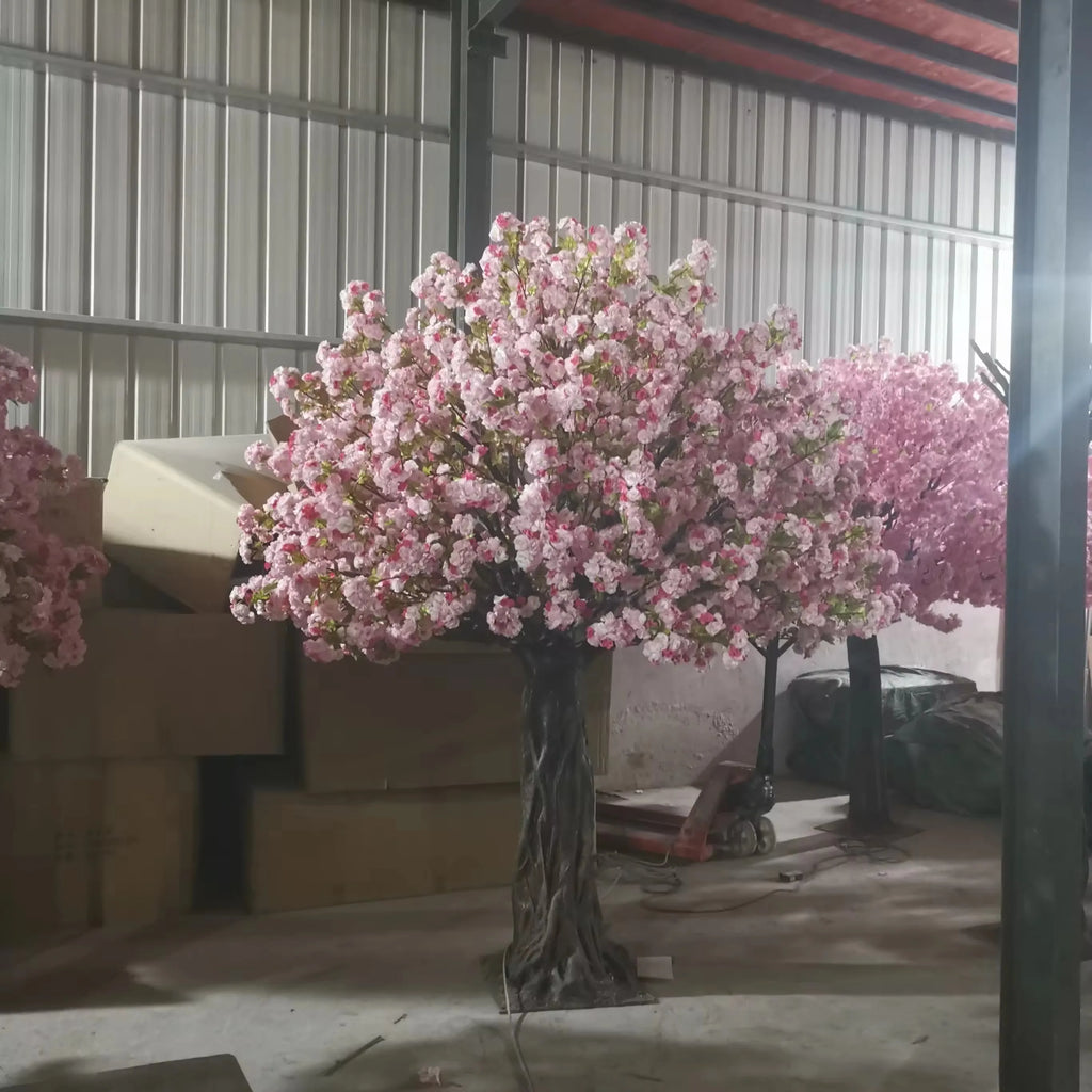 The pink blossom tree used as a centrepiece display at a wedding reception
