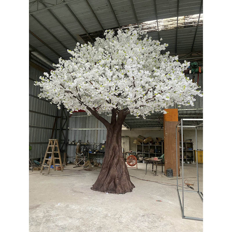 The white sakura tree styled as a table centrepiece at a wedding reception