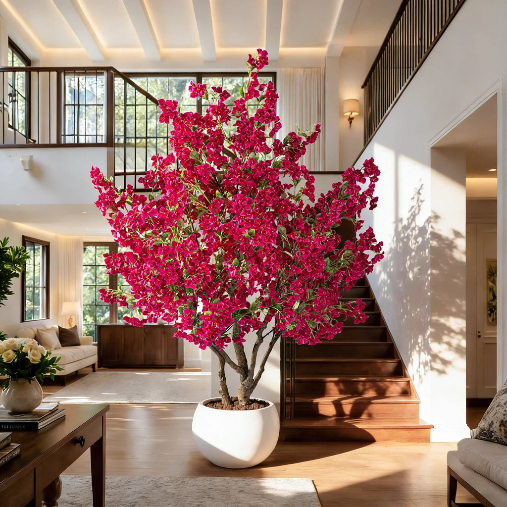 The flowering tree in a hotel lobby, its colour set against a pale stone wall