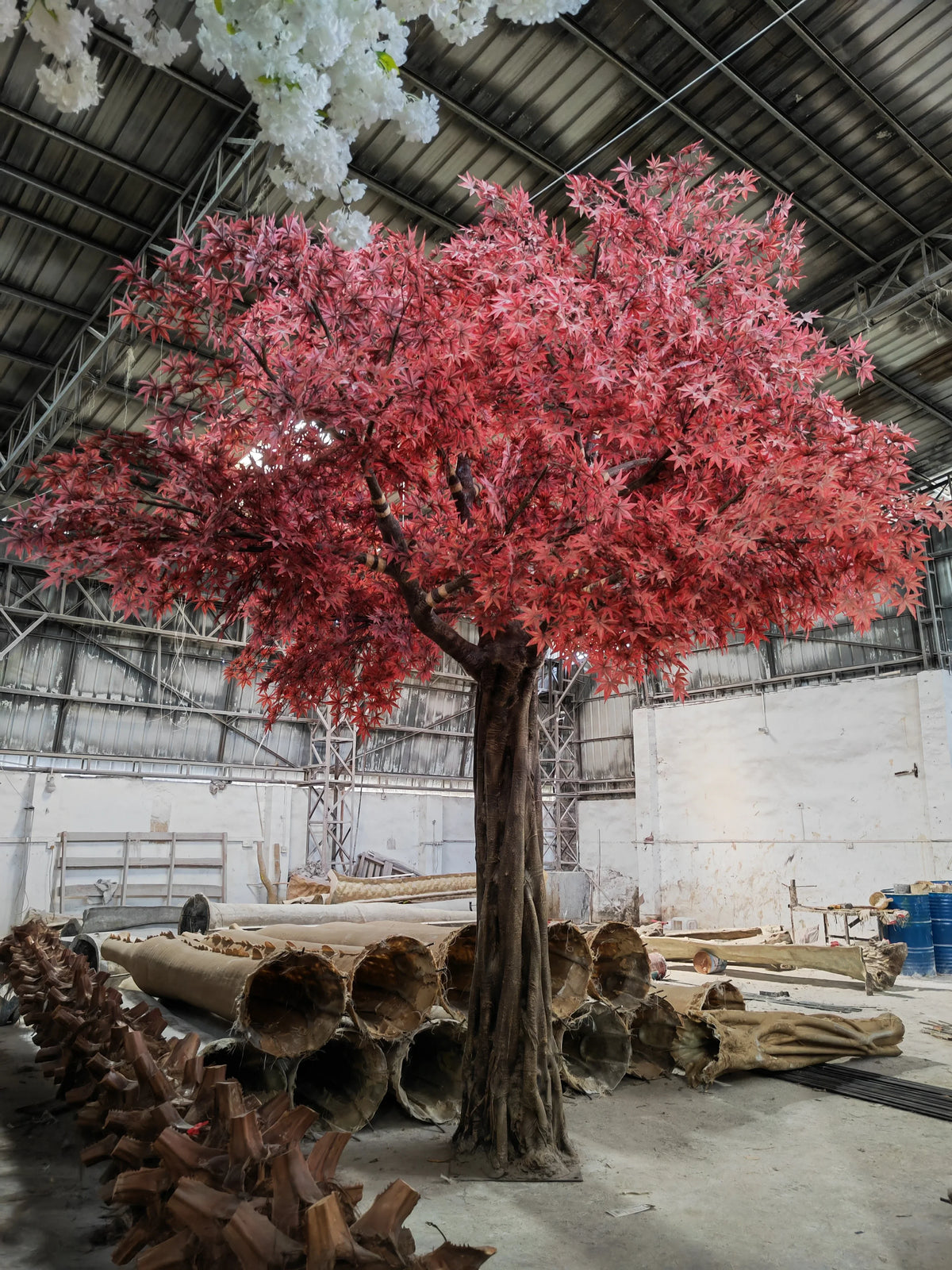 Base of the 17ft artificial maple where the trunk meets its floor planter