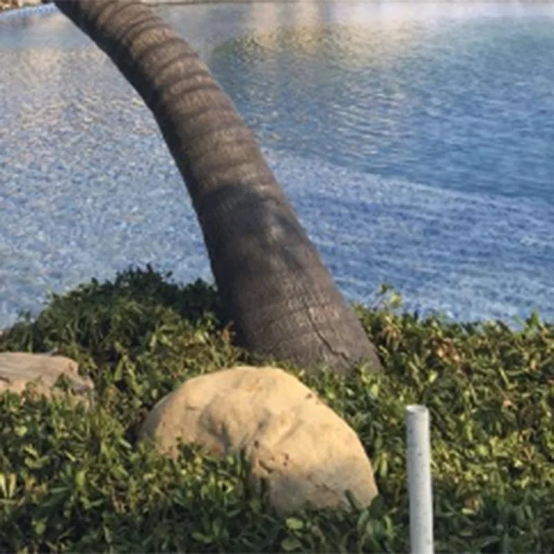 Base of the artificial date palm where the trunk meets its planter