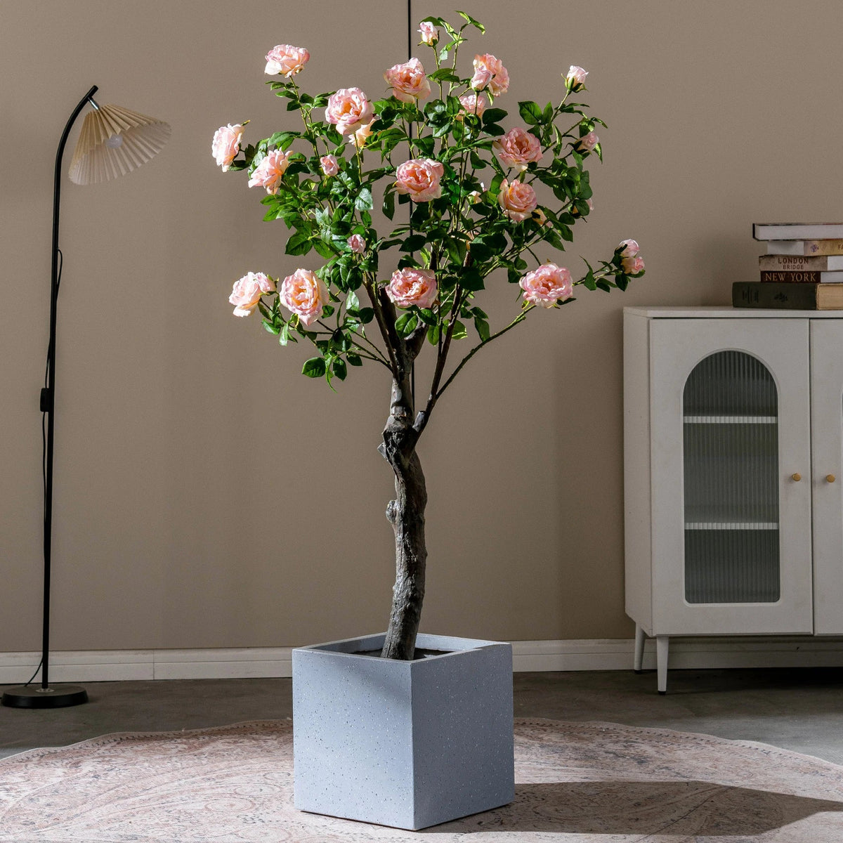 The trunk and pot of the 5ft pink rose tree as it stands on the floor