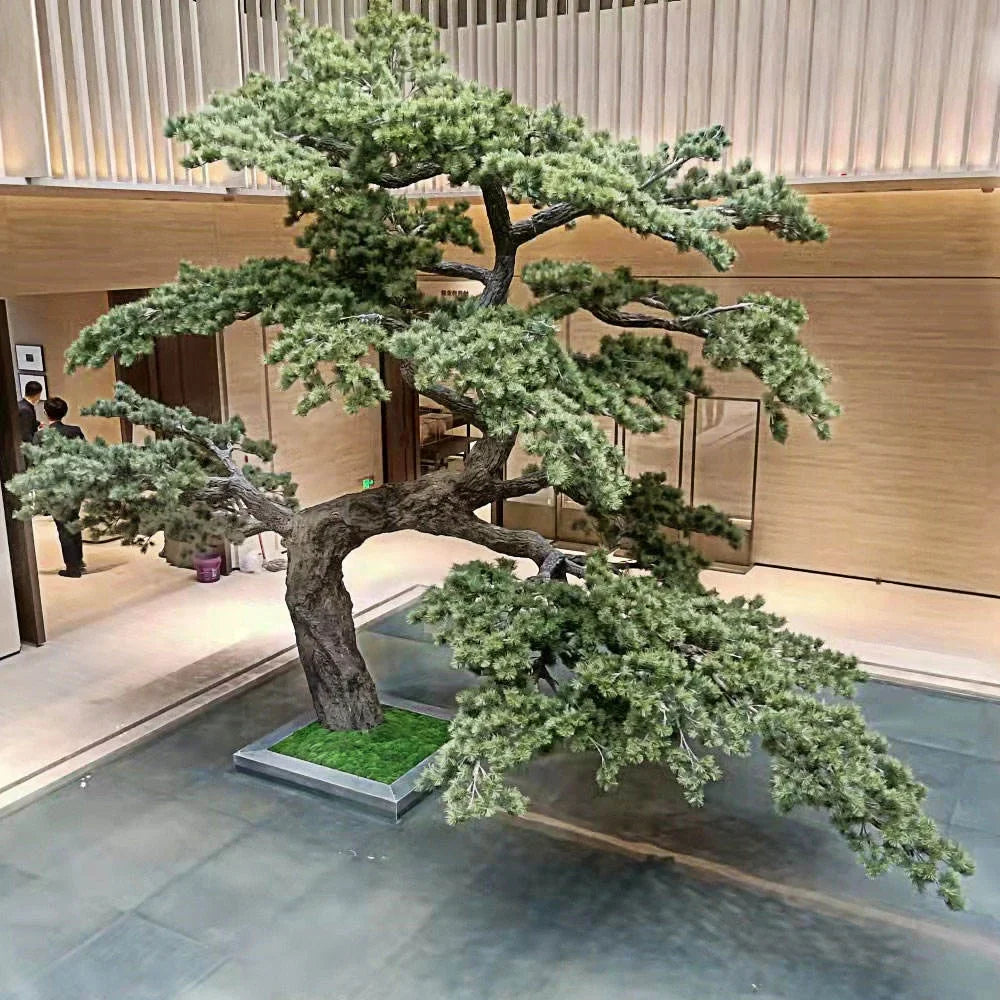 The pine bonsai used as a landscape feature beside a hotel entrance