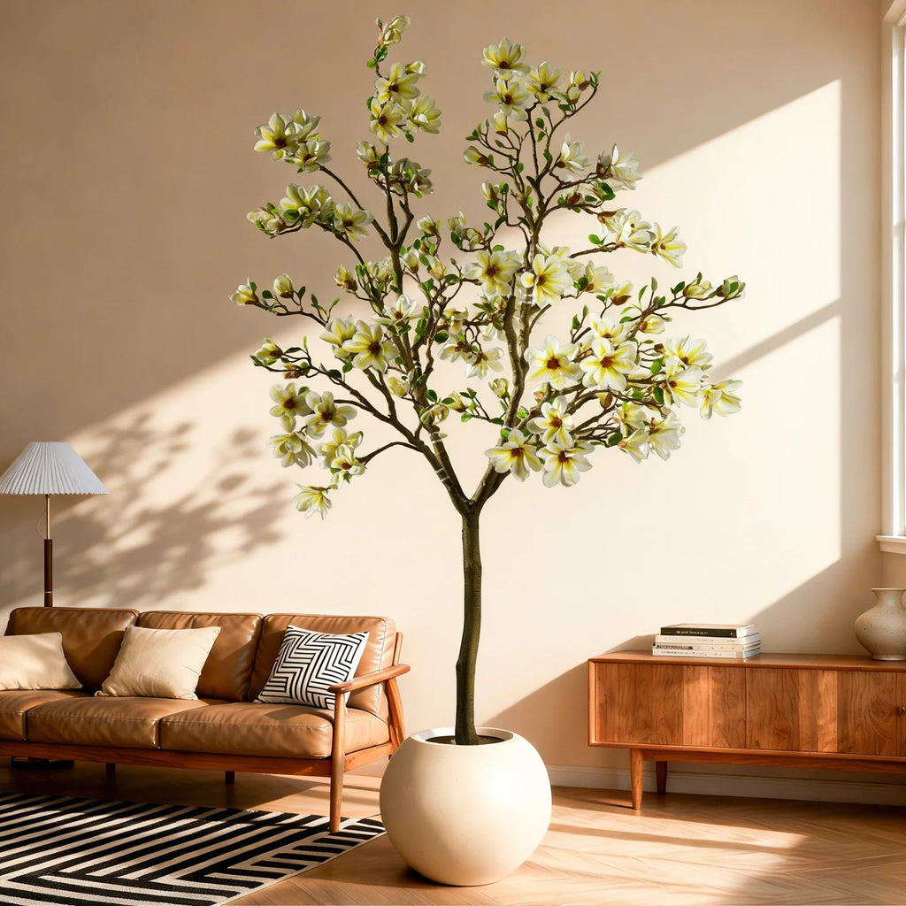 Artificial magnolia tree with large blooms set among glossy plastic green leaves