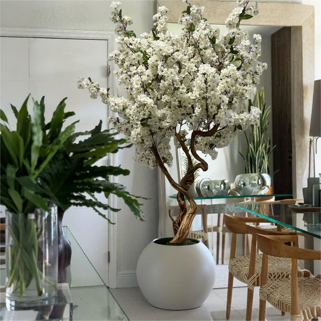 Artificial cherry blossom tree with pink and white blooms massed on bare branches