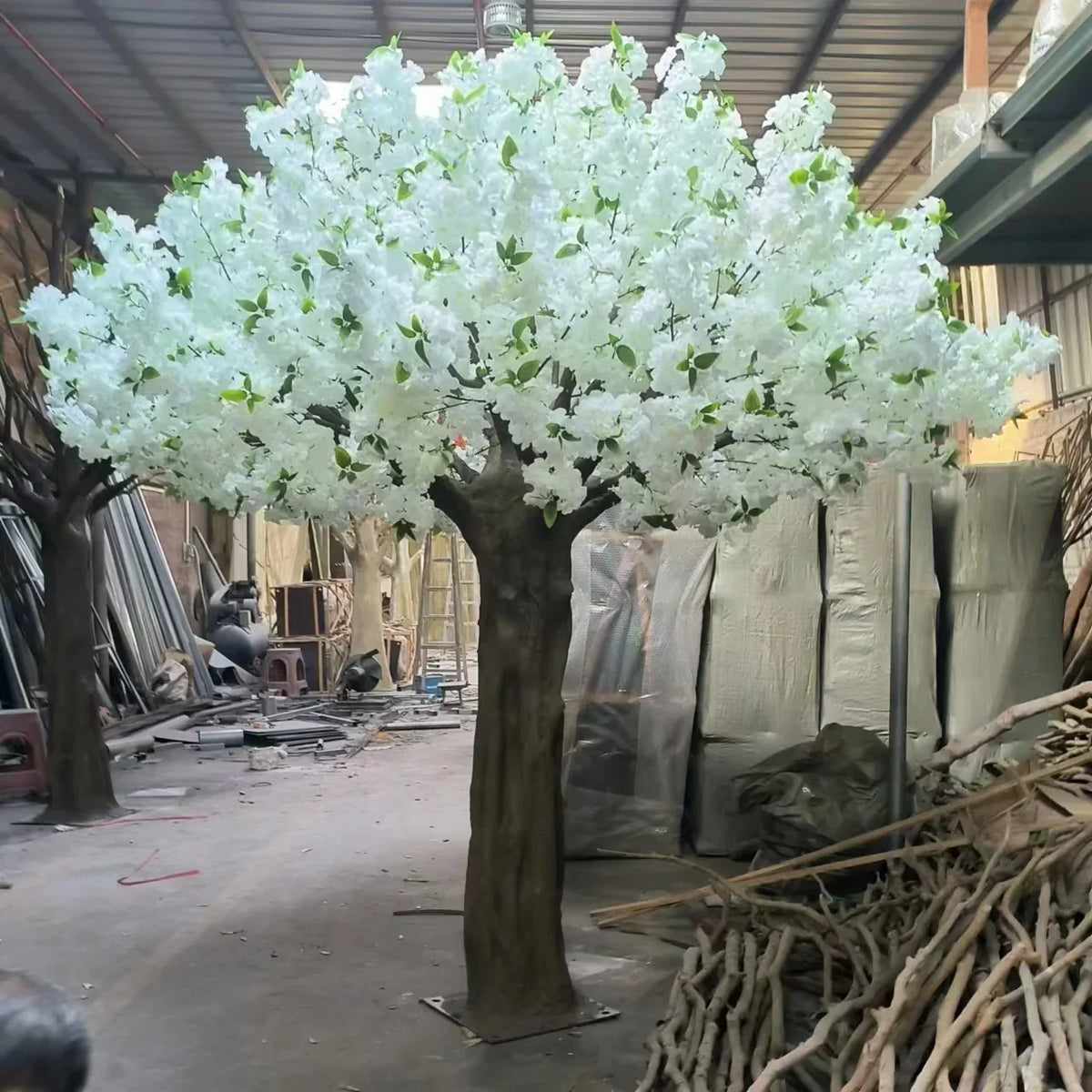 Close-up of the silk sakura flowers massed along each of the arching branches