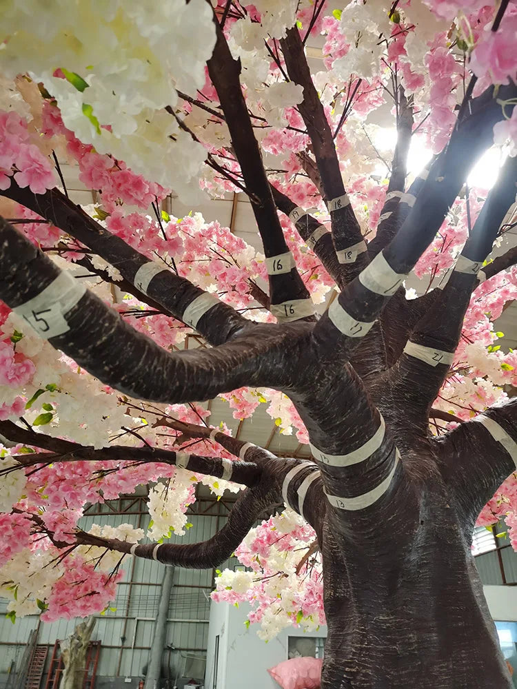 The sakura tree standing in a restaurant interior beside the dining tables