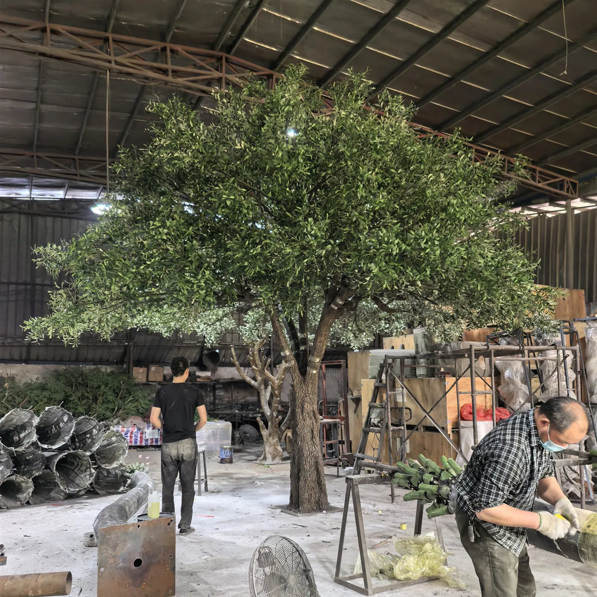 Base of the 4m artificial olive tree where the trunk meets its planter